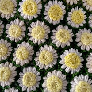 Large hand knitted daisy granny blanket.